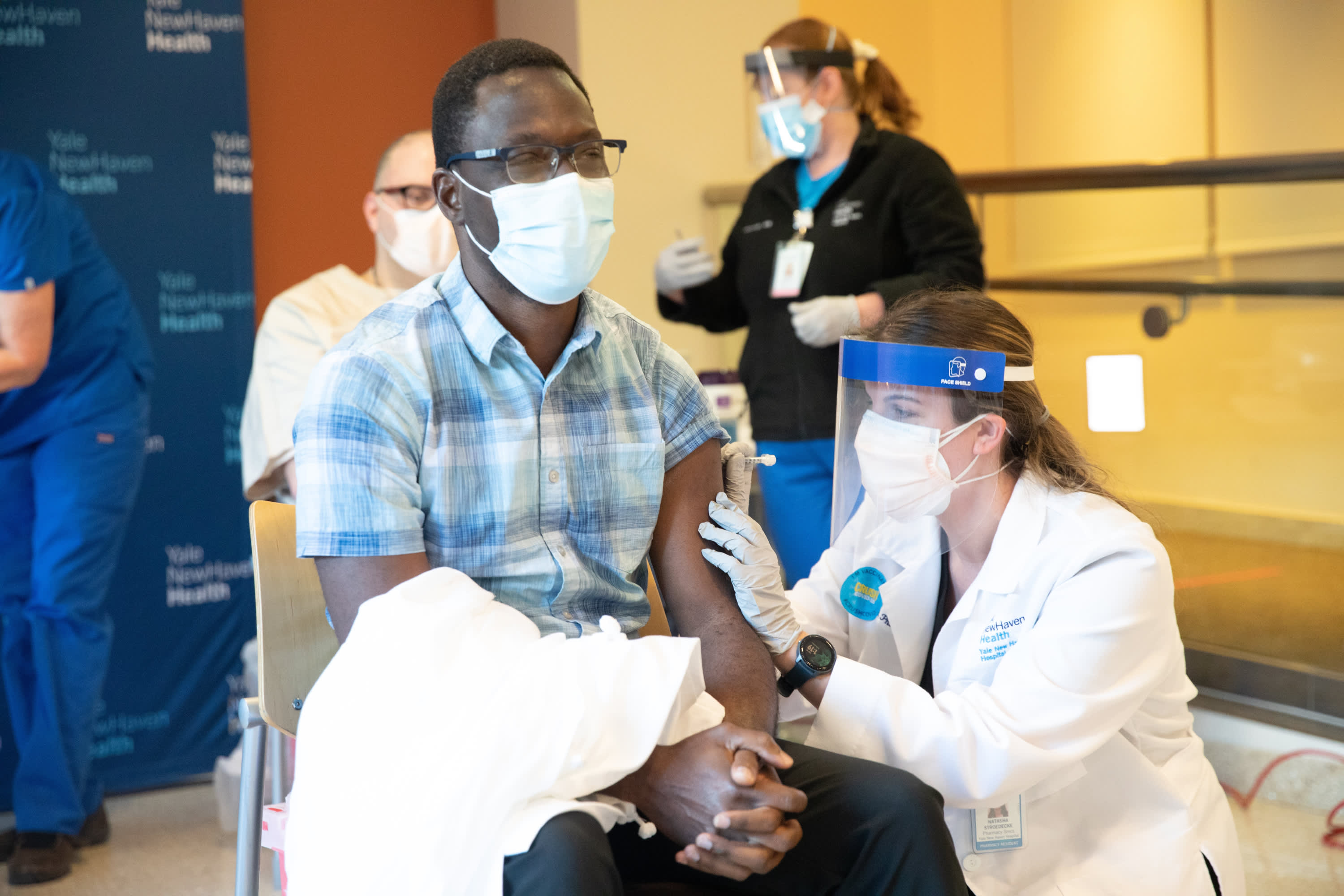 Onyema Oguagu, MBBCh, receiving a dose of the COVID-19 vaccine.