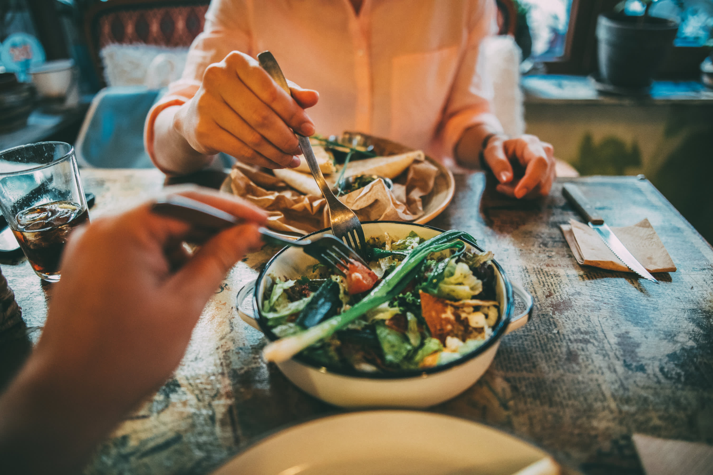 couple sharing a salad after taking anti-obesity medications