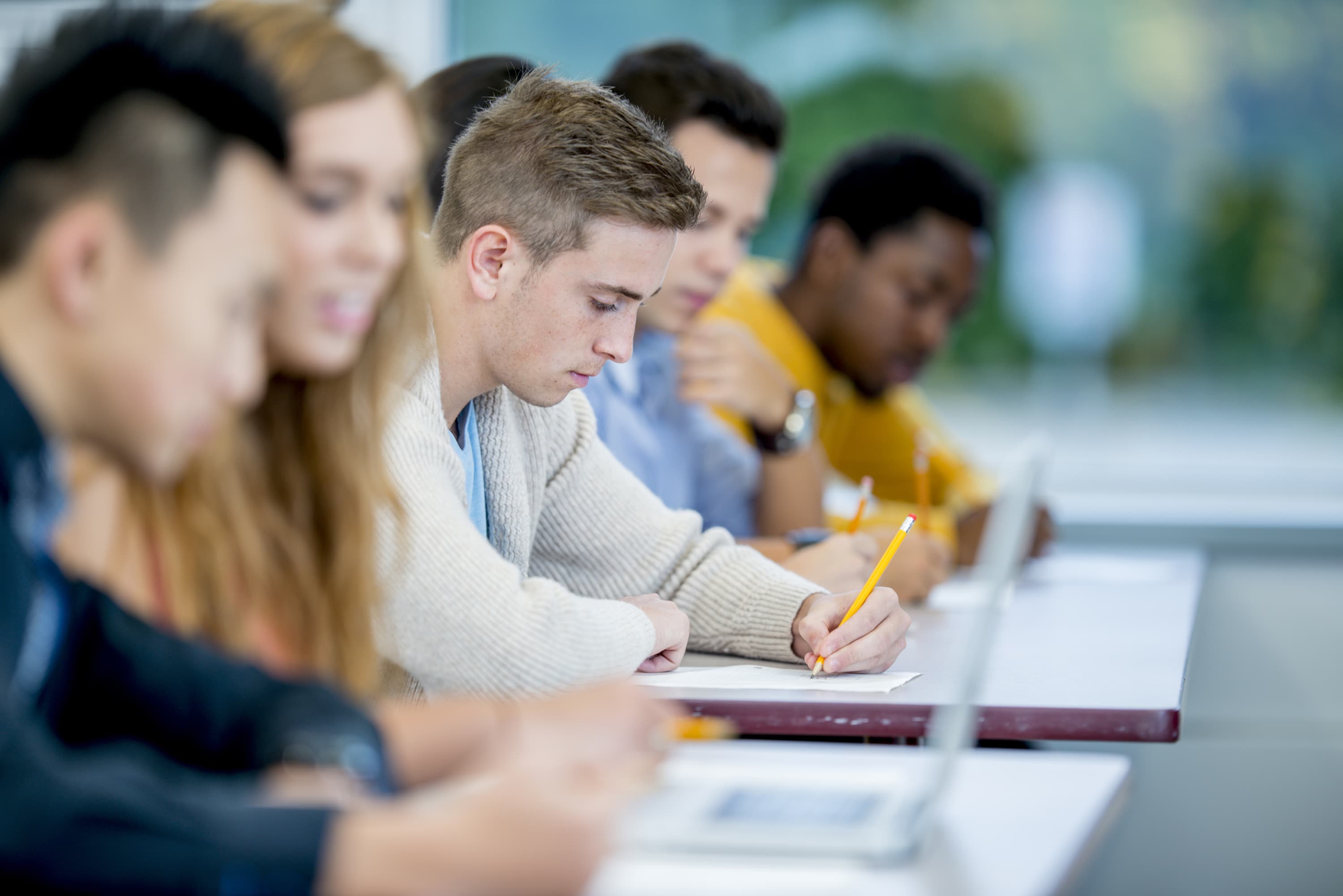 college kid taking a test while managing his diabetes