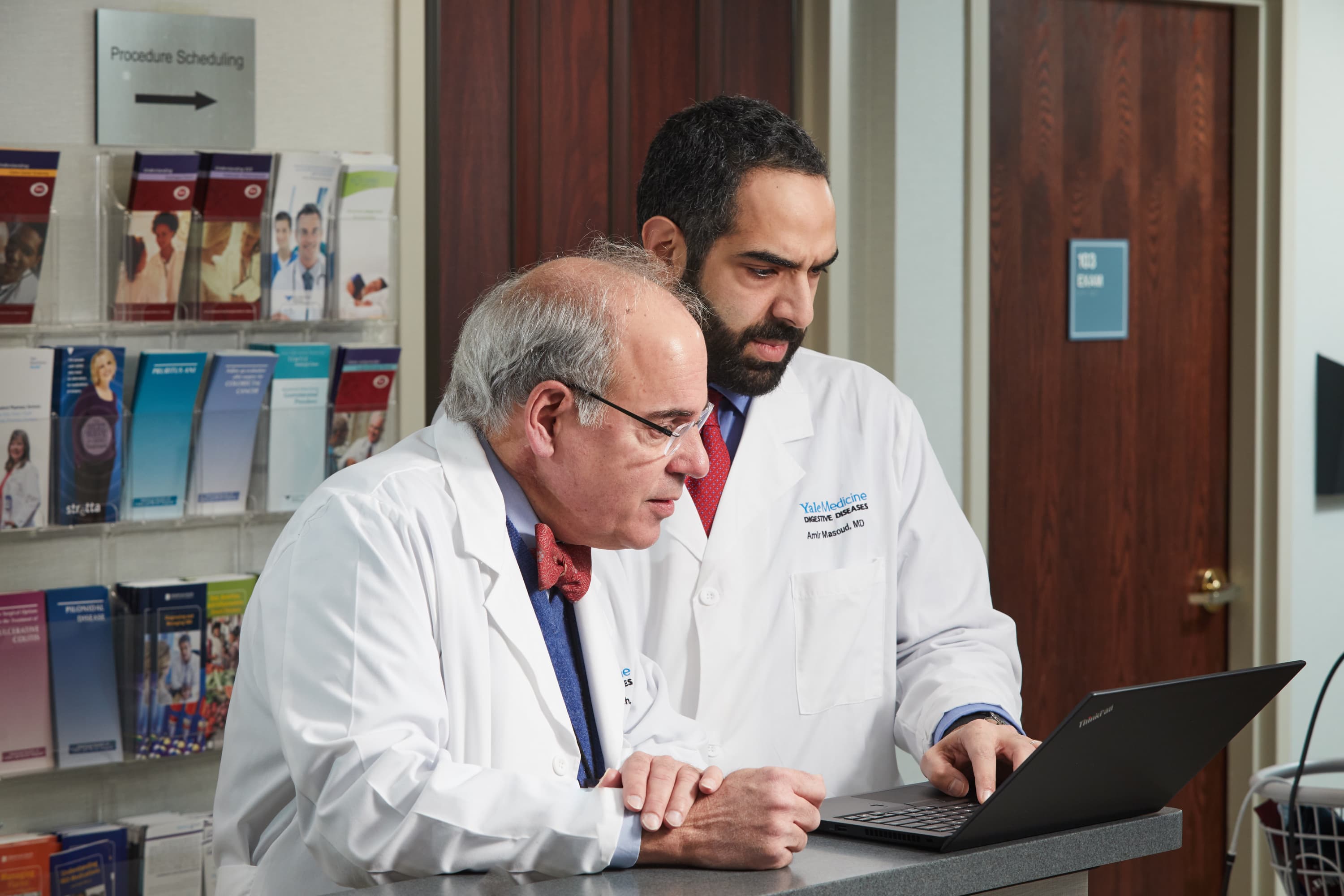 William Ravich, MD, consults with a colleague about a GI case. 